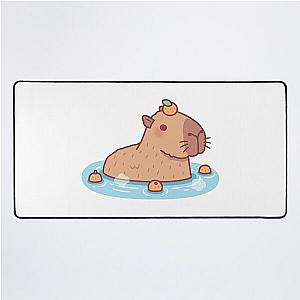 Cute Capybara With Orange On Head Chilling In Hot Spring Desk Mat