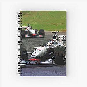 Mika Hakkinen racing his 1998 MP 4-13 F1 race car on a spiral notebook