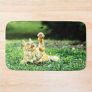 Friendly cat in the garden says hey to a leaf! Bath Mat