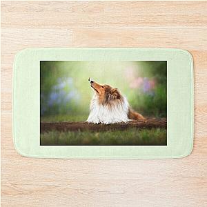 Rough Collie dog relaxes in the garden  Bath Mat